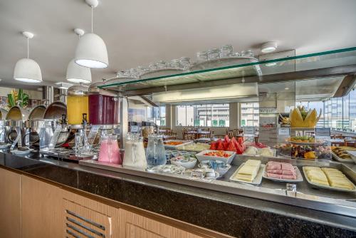 a buffet line with many different types of food at Tambaqui Praia Hotel in Maceió
