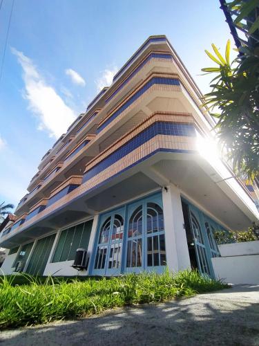 a building with the sun shining through the windows at Coliseu Palace Residence in Florianópolis