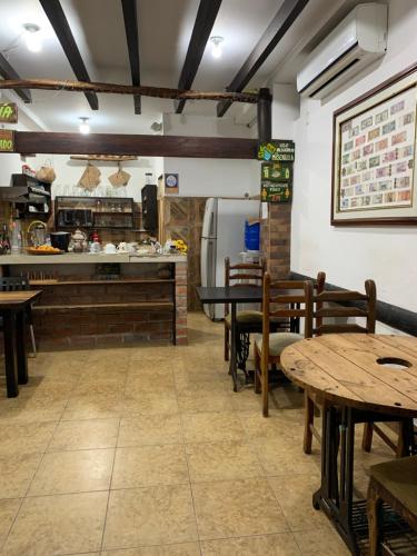 a dining room with tables and a kitchen at Hotel La Barca in Atacames