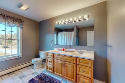 a bathroom with a sink and a toilet and a mirror at Martin Grandview Estate in Lancaster