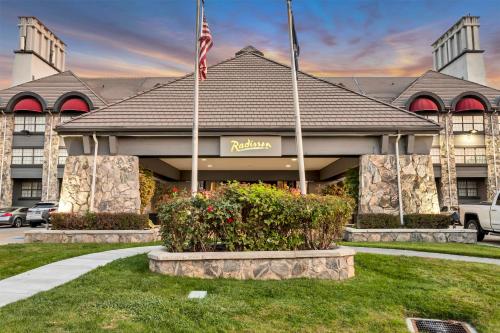 a hotel with an american flag in front of a building at Radisson Hotel Salt Lake City Airport in Salt Lake City