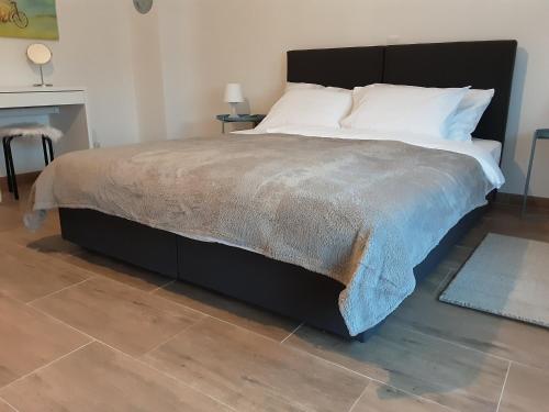 a bedroom with a large bed with white pillows at Villa Sorella Baranja in Karanac