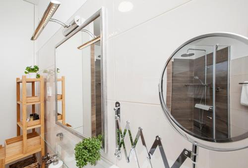 a bathroom with a large mirror on the wall at Apartma Thermos in Krapinske Toplice