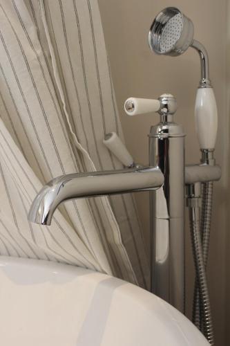 a bed with a shower and a blow dryer at Maison Caju - La Rochelle in La Rochelle