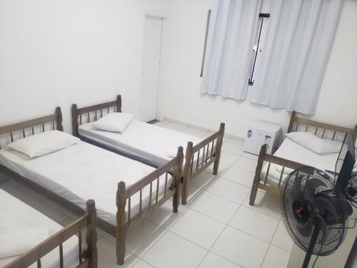 Giường trong phòng chung tại Pousada alojacampinas