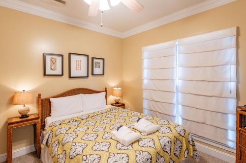 a bedroom with a bed with two pillows on it at 2B Pavilion Watch in Folly Beach