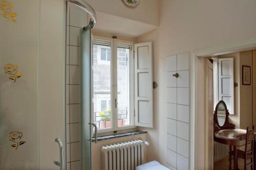 baño con ducha y ventana en Dolce Rosa ♡ Centro Storico, en Sansepolcro