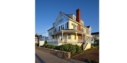 a large white house on the side of a street at The Beach House Inn in Kennebunk