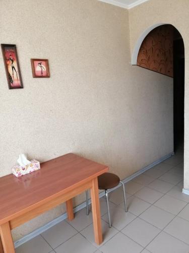 a table and a chair in a room at Квартира поблизу озера, паркова зона in Ternopilʼ