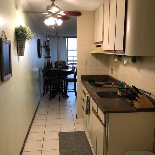 a kitchen with a table and a ceiling fan at Marina Lanais Condominio in Las Croabas
