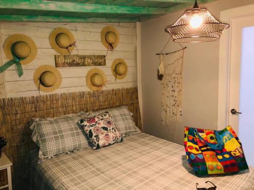 ein Schlafzimmer mit einem Bett mit Hüten an der Wand in der Unterkunft Independent Studio in Little Havana - 4V in Miami