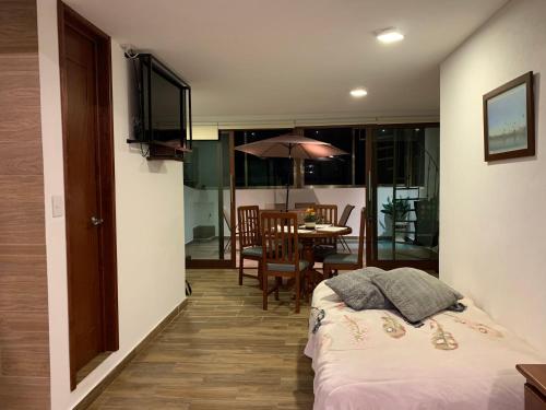 a bedroom with a bed and a dining room with a table at Loft Don Silver in Zacatlán