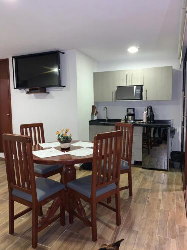 uma cozinha e sala de jantar com mesa e cadeiras em Loft Don Silver em Zacatlán