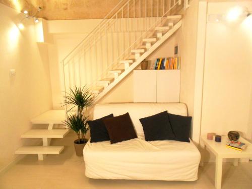 a white couch in a room with a staircase at Twins Apartments in Bari