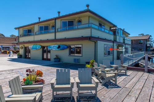a building with chairs on a wooden deck at Estero Inn in Morro Bay