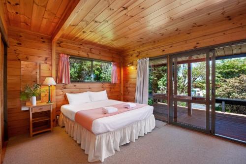 a bedroom with a bed in a log cabin at Lake Terrace Lockwood in Taupo