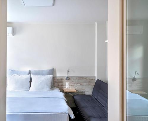 a hotel room with a bed and a couch at Design Hotel Wiegand in Hannover