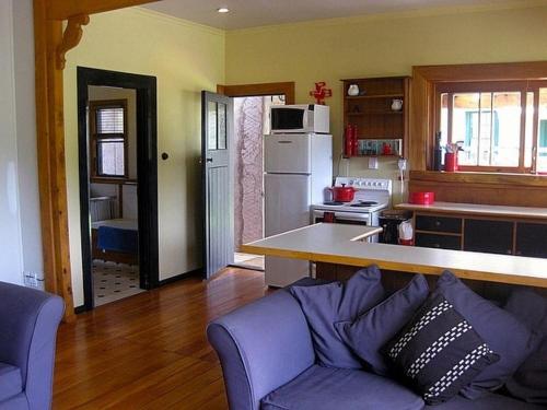 a kitchen with a purple couch in a room at The Ski House on Miharo - Rangataua Holiday Home in Ohakune
