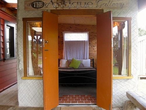 an open door to an outdoor patio with a bed at The Ski House on Miharo - Rangataua Holiday Home in Ohakune