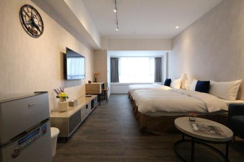 a hotel room with a large bed and a couch at MU House in Taipei