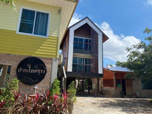 a house with a sign on the side of it at Baan I-A-run Resort in Pak Chong
