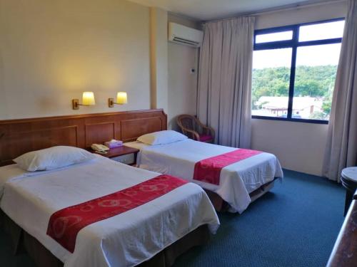 Postel nebo postele na pokoji v ubytování Pacific Orient Hotel ( 凯富大酒店 )