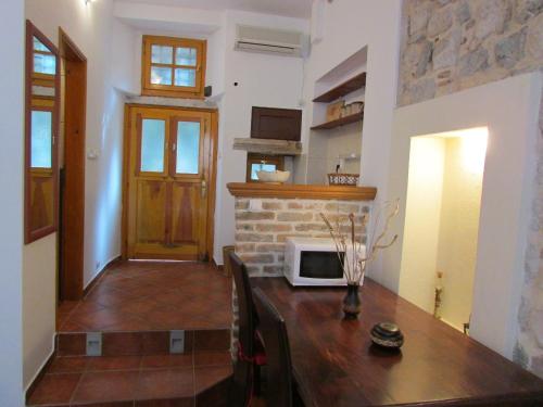 a kitchen with a table with a microwave on it at Apartments Popovic in Kotor