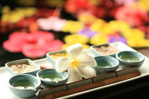 a tray with several bowls and a flower on it at Palau Pacific Resort in Koror