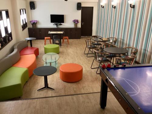a room with tables and chairs and a pool table at Honeymoon Inn Mussoorie in Mussoorie