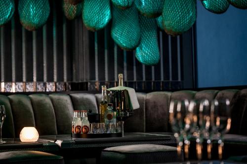 a bar with a couch and a table with glasses at Kempinski Hotel Hangzhou in Hangzhou