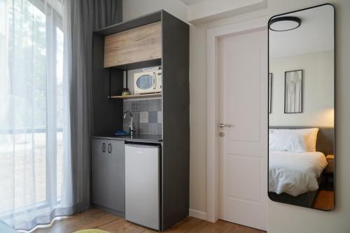 a room with a kitchen with a microwave and a bed at Apartique Hotel in Jerusalem