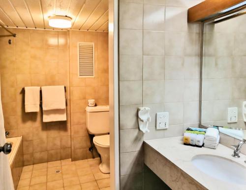 a bathroom with a toilet and a sink and a shower at Breakfree Wirrina Cove in Wirrina Cove