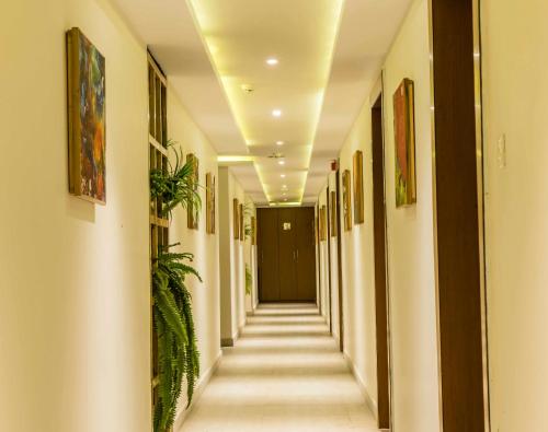a hallway of a building with paintings on the walls at Club Central in Bolpur