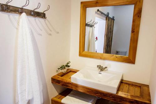 a bathroom with a sink and a mirror at Blue Lily Retreat in Matjiesrivier