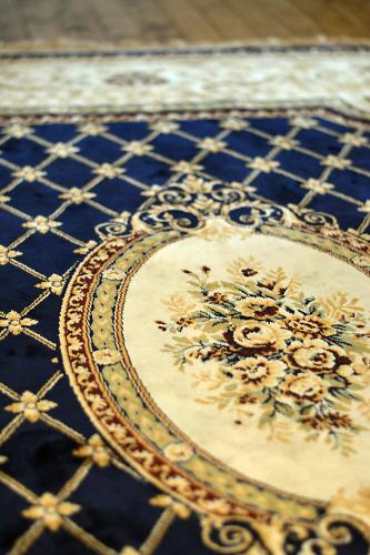 a blue and white rug with a floral design on it at Anchor Inn Hotel and Suites in Twillingate