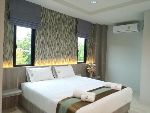a bedroom with a large white bed with two pillows at Lailaresidence in Yala