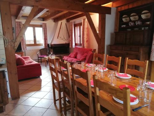 a dining room with a long table and chairs at Adret in Saint-Martin-de-Belleville