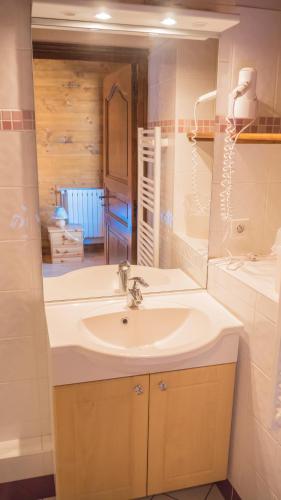 a bathroom with a sink and a mirror at Adret in Saint-Martin-de-Belleville
