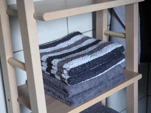 a stack of towels sitting on a shelf at Ferienwohnung an der Waldmühle in Reulbach
