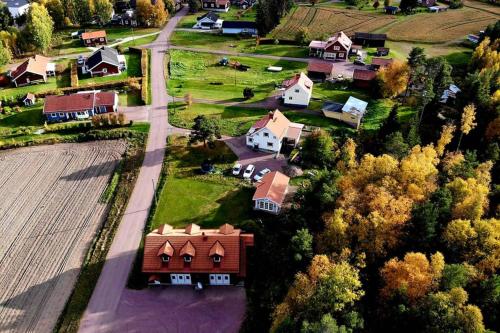 an aerial view of a house with a farm at Nybyggd stuga intill skogsbrynet - New built cottage next to the cowberry forest in Mora