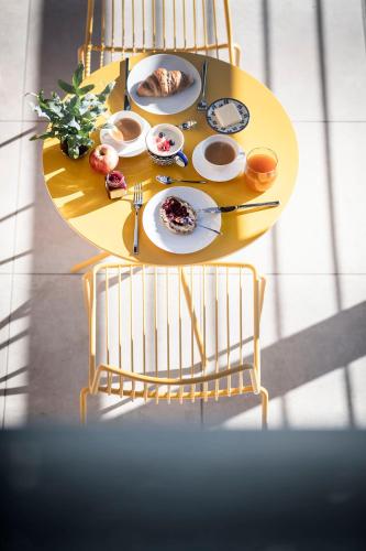 a yellow table with plates of food on it at OVINA`s HAUS in Sand in Taufers