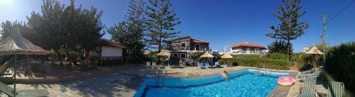 a swimming pool in front of a house at Villa Medusa in Hersonissos