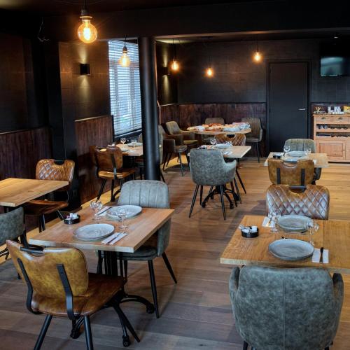 a dining room with wooden tables and chairs and tablesktop at Hotel & Restaurant Maison Pal'Ange in Durbuy