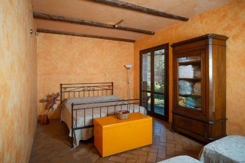a bedroom with a bed and a dresser and a window at Katia Loreti in Capodacqua di Foligno