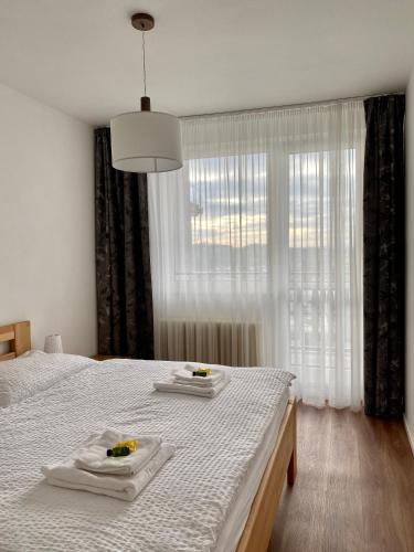 a bedroom with a bed with two towels on it at Prázdninový dům Holubka in Nové Město na Moravě