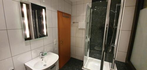 a bathroom with a sink and a shower at Ferienwohnung Wille in Lünen
