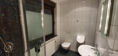 a bathroom with a toilet and a sink and a shower at Ferienwohnung Wille in Lünen
