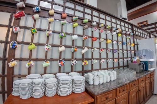 a wall with a bunch of plates and ornaments at Pousada Brisa do Mar in Torres
