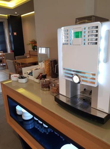 a coffee maker sitting on a counter in a restaurant at Hotel Brazão in Vila do Conde