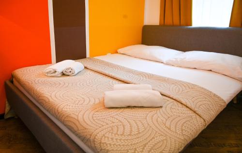 a bed with two towels on top of it at Elegant Apartment Westbahnhof in Vienna